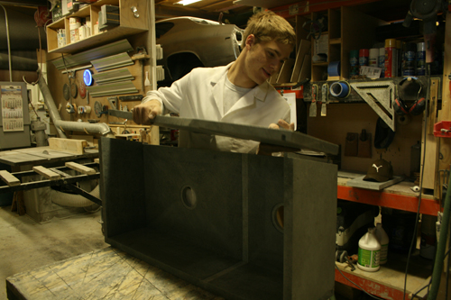 Greg Seuren putting the front on the front of a Soapstone Sink